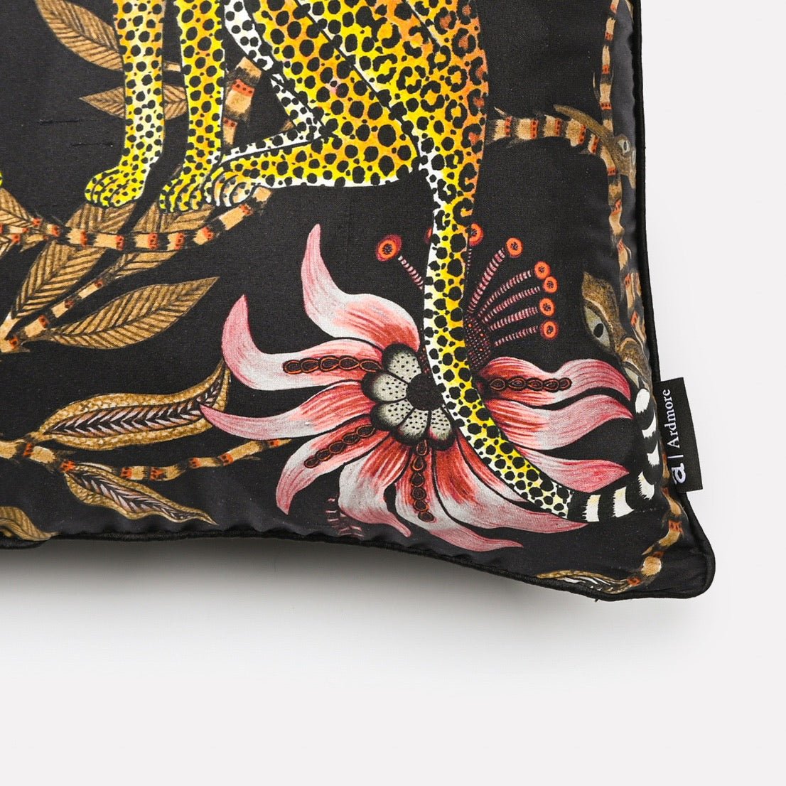 Side angle view of the Lovebird Leopards Night cushion cover, highlighting the detailed leopard and floral print against the sleek black background.