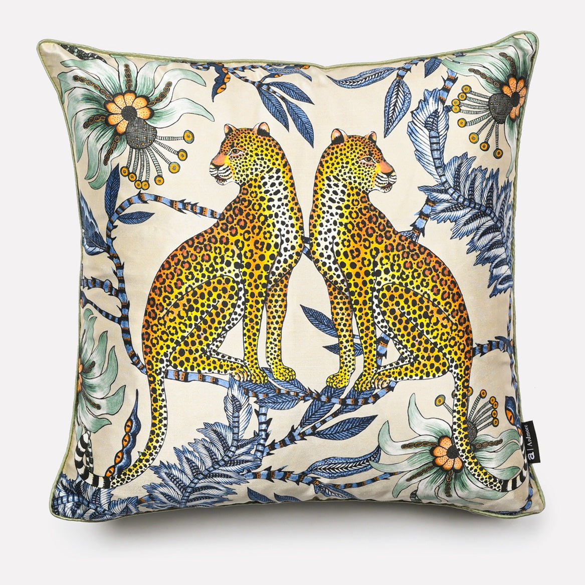 Cushion cover in Lovebird Leopards Tanzanite design, showcasing a vibrant print with two leopards surrounded by floral elements in shades of blue and green on a tanzanite-coloured background.