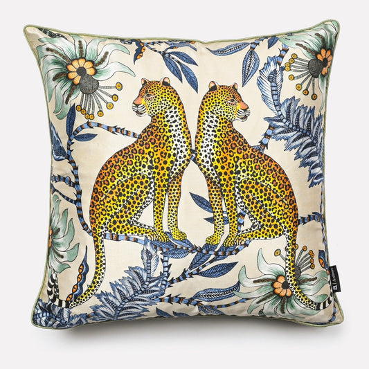 Cushion cover in Lovebird Leopards Tanzanite design, showcasing a vibrant print with two leopards surrounded by floral elements in shades of blue and green on a tanzanite-coloured background.