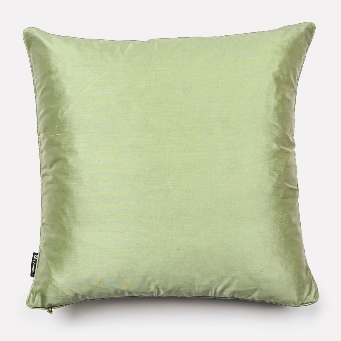 Back view of the Lovebird Leopards Tanzanite cushion cover in soft pistachio-coloured silk, highlighting the smooth texture and subtle elegance.