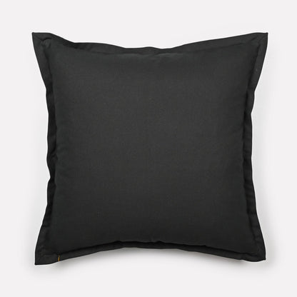 Back view of the Meandering Monkey Oasis cushion cover in solid black fabric with the Ardmore logo.