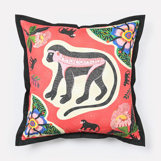 Front view of the Meandering Monkey Sunset Cushion Cover, featuring a vibrant sunset-coloured fabric with a playful monkey motif and floral details.