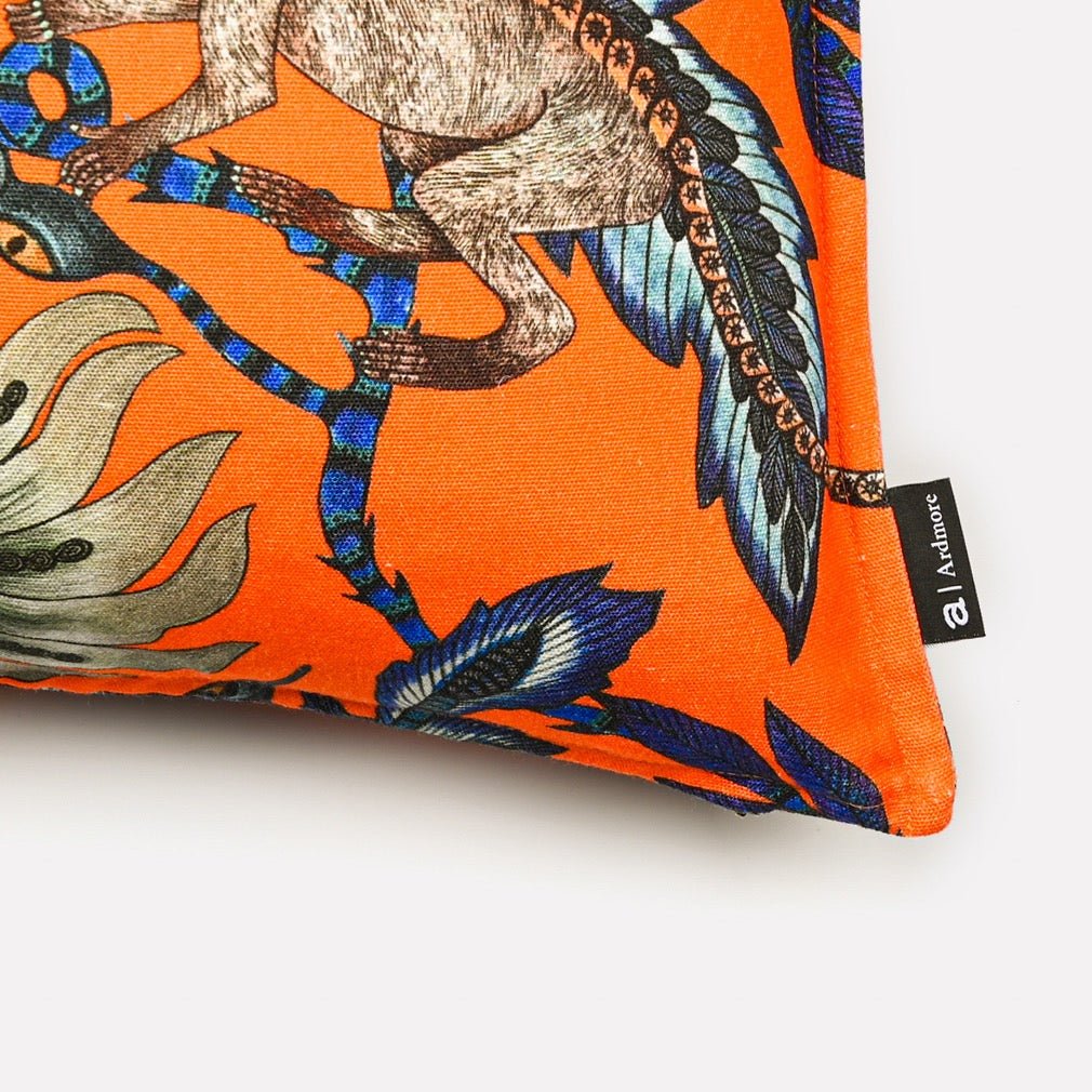 Close-up view of the Monkey Bean Flame Linen cushion cover, highlighting detailed cheetah illustrations and bold floral accents.