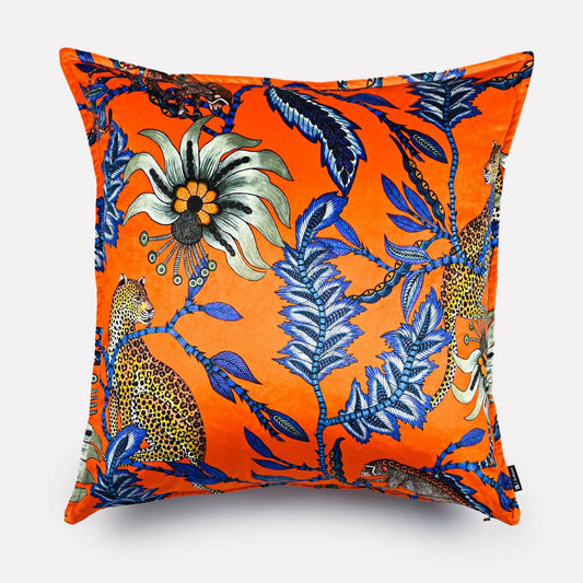 Velvet cushion cover in Monkey Bean Flame design, showcasing vibrant orange fabric with intricate blue and floral patterns, displayed against a plain background.
