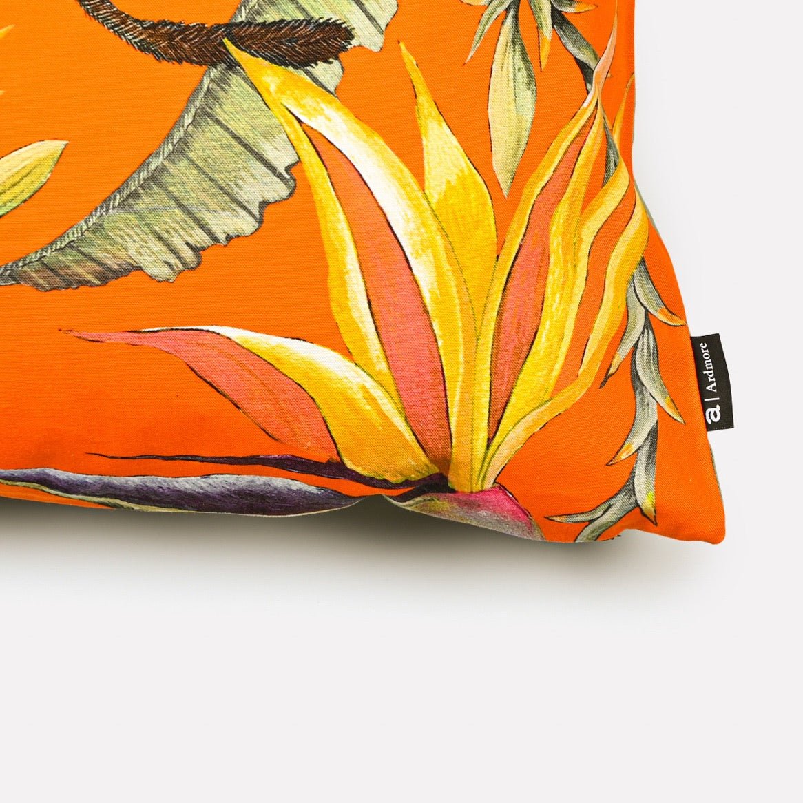 Close-up of the Monkey Paradise Flame Cushion Cover, highlighting the intricate leaf and monkey design on the bright orange background.