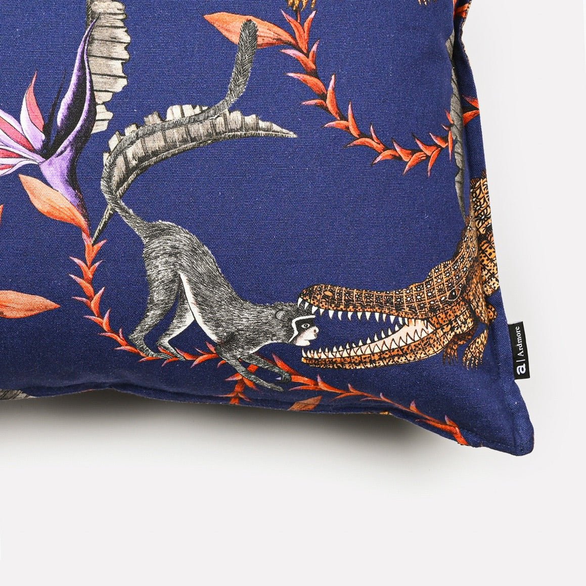 Close-up side view of the River Chase Royal Linen cushion cover highlighting the bold crocodile motifs and fine fabric texture.