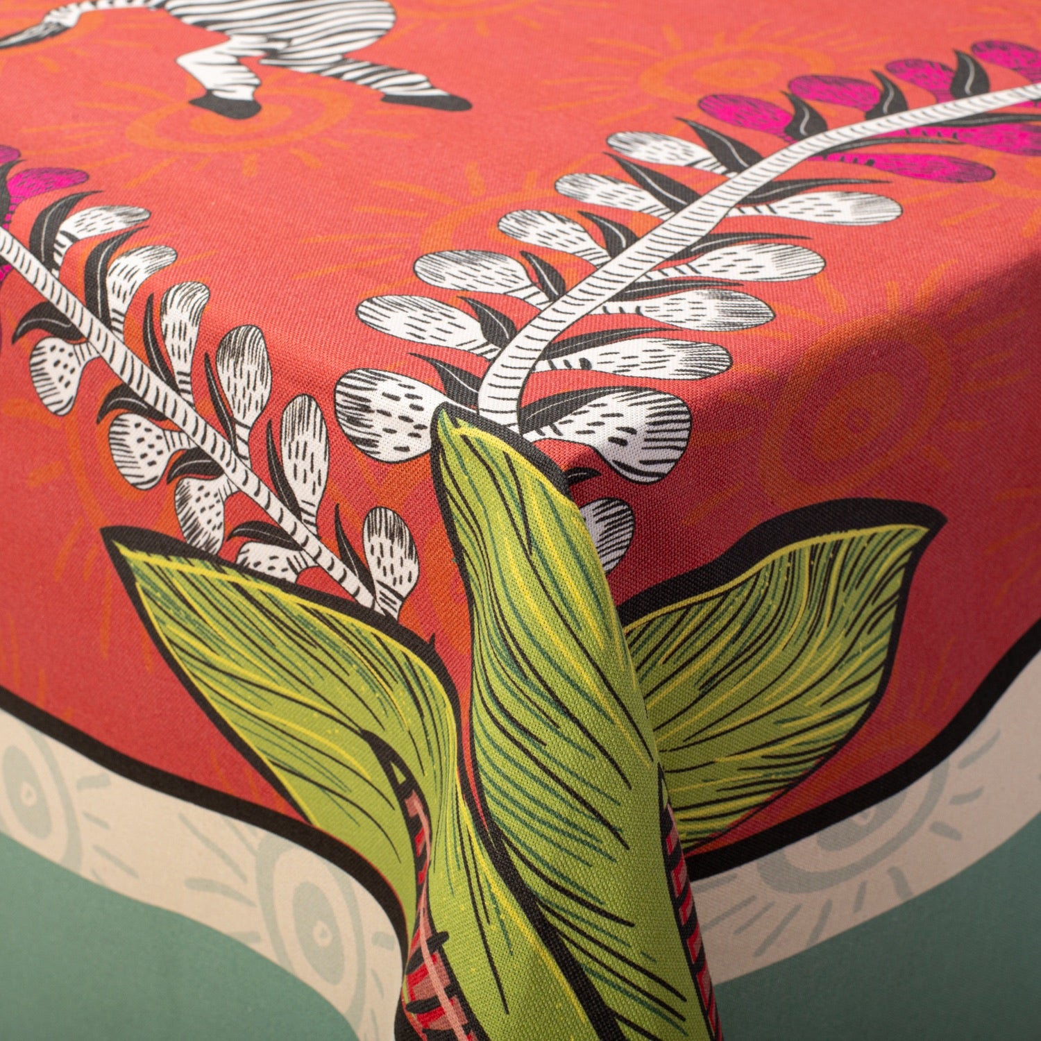 A macro shot focusing on the botanical patterns, highlighting the lush green leaves and delicate floral artwork.