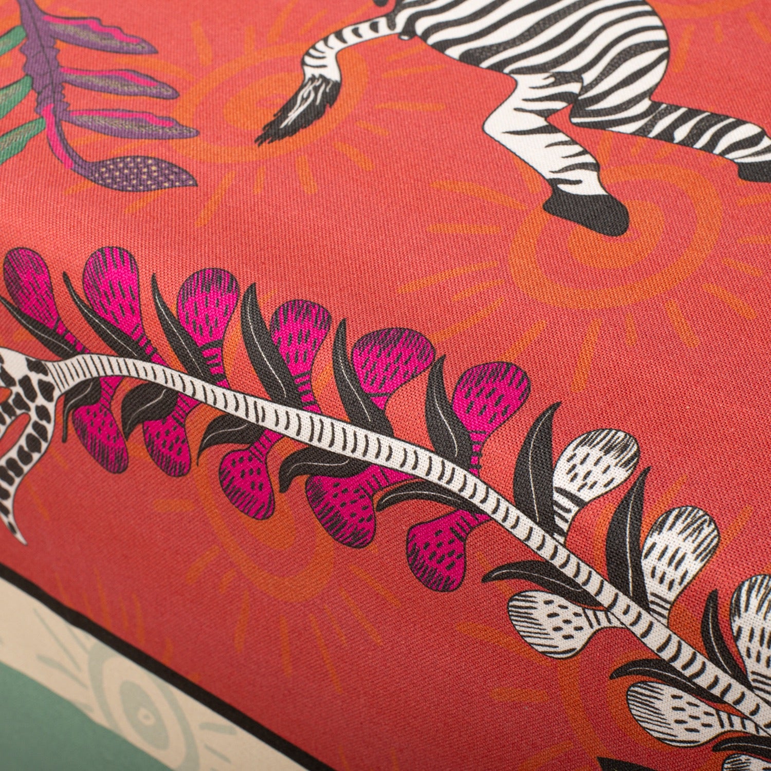 A zoomed-in section capturing the fine illustration of a zebra, surrounded by the bold red background and intricate floral elements.