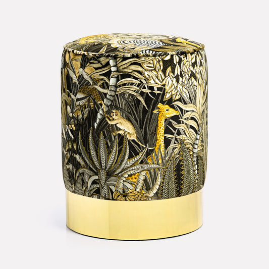 Elegant velvet pouffe featuring Ardmore's Sabie Forest Moonlight design, with intricate golden and black botanical patterns, set atop a gleaming brass base for a touch of luxury.