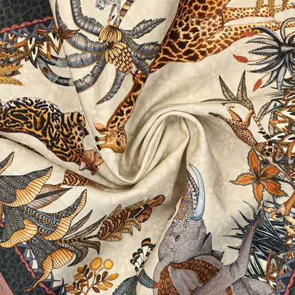 A swirled fabric presentation of the Ardmore Sabie Forest Napkin in Stone, emphasizing the soft cotton material and the flowing, intricate print design.