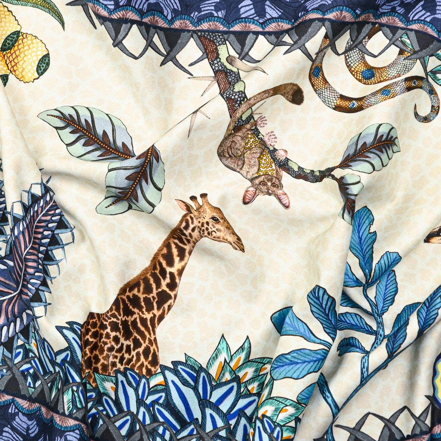 A zoomed-in view of the table runner, featuring lush foliage and exotic animals like leopards and birds, highlighting the fine artistic detailing.