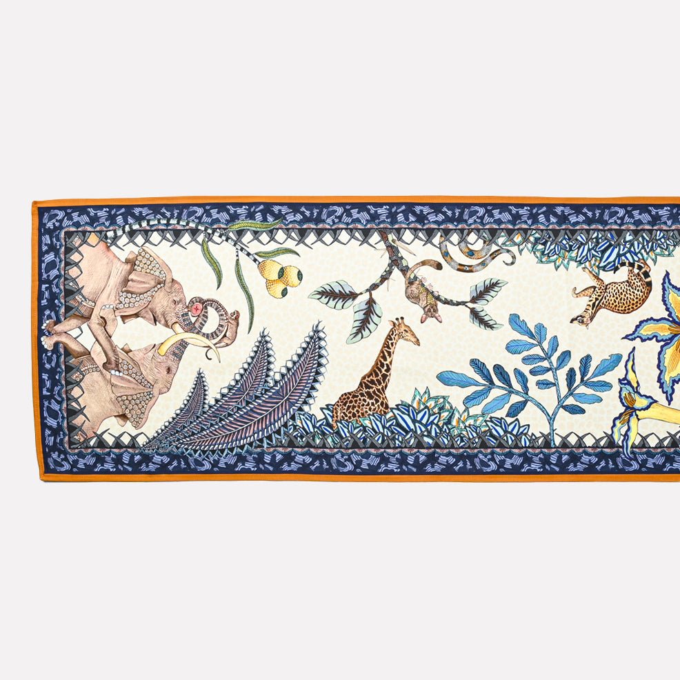 A flat-lay image displaying a single Sabie Forest Table Runner, showcasing its elegant border design and detailed nature-inspired print.