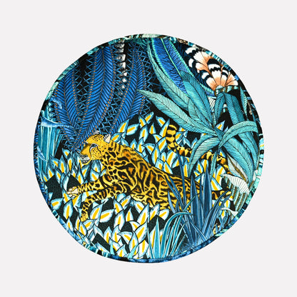 Top-down perspective of the Ardmore Sabie Forest Tanzanite Pouffe, revealing its rich, nature-inspired artwork in deep blue and gold hues, adding a regal touch to any space.