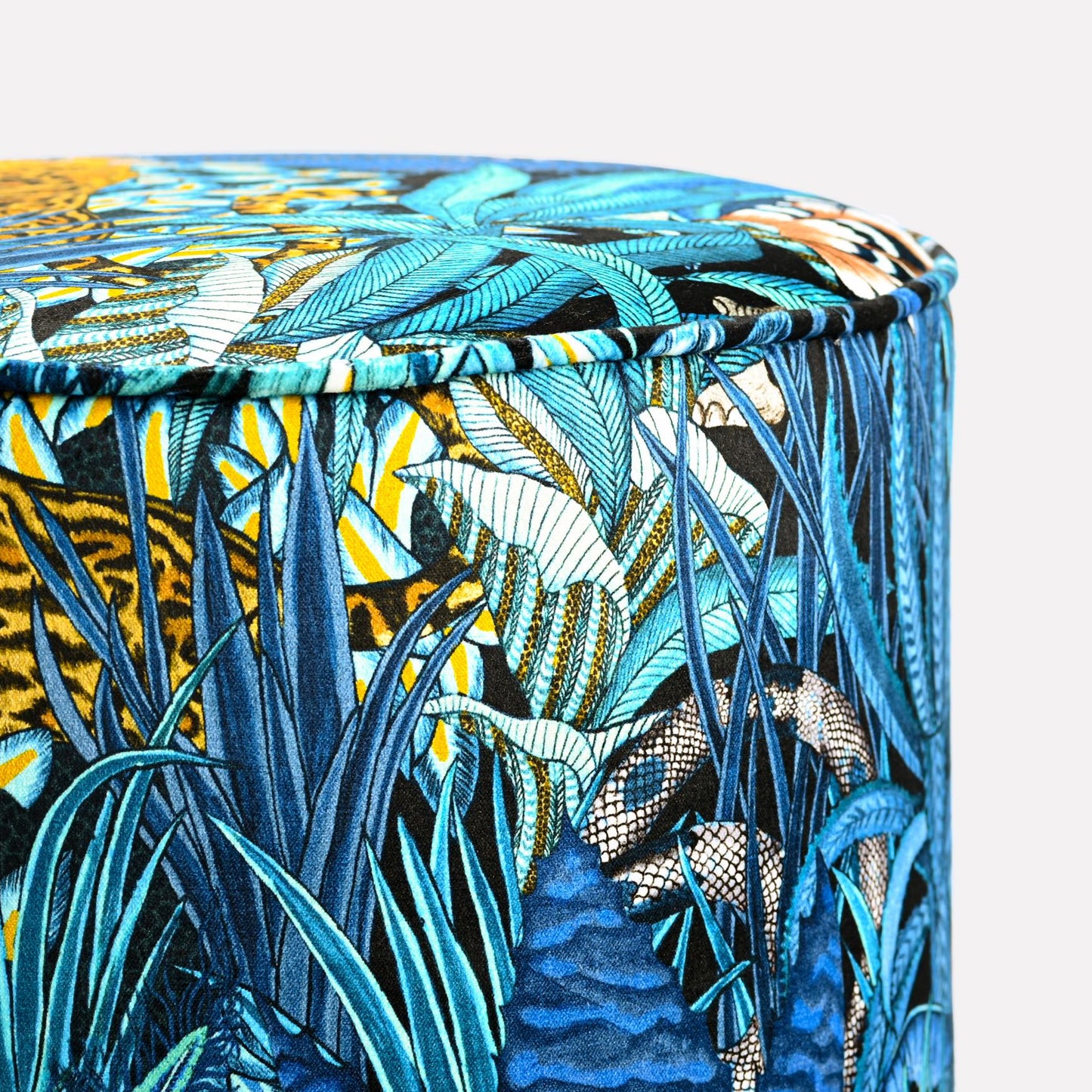Close-up view of the Ardmore Sabie Forest Tanzanite Pouffe, highlighting its intricate blue and gold botanical detailing, exuding a blend of African heritage and contemporary luxury.