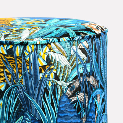 Close-up view of the Ardmore Sabie Forest Tanzanite Pouffe, highlighting its intricate blue and gold botanical detailing, exuding a blend of African heritage and contemporary luxury.