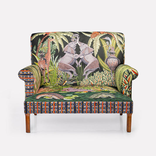 Front view of the Ardmore Sabie Sofa in Delta, showcasing its vibrant tapestry of elephants, monkeys, and King Cheetah on lush velvet fabric.