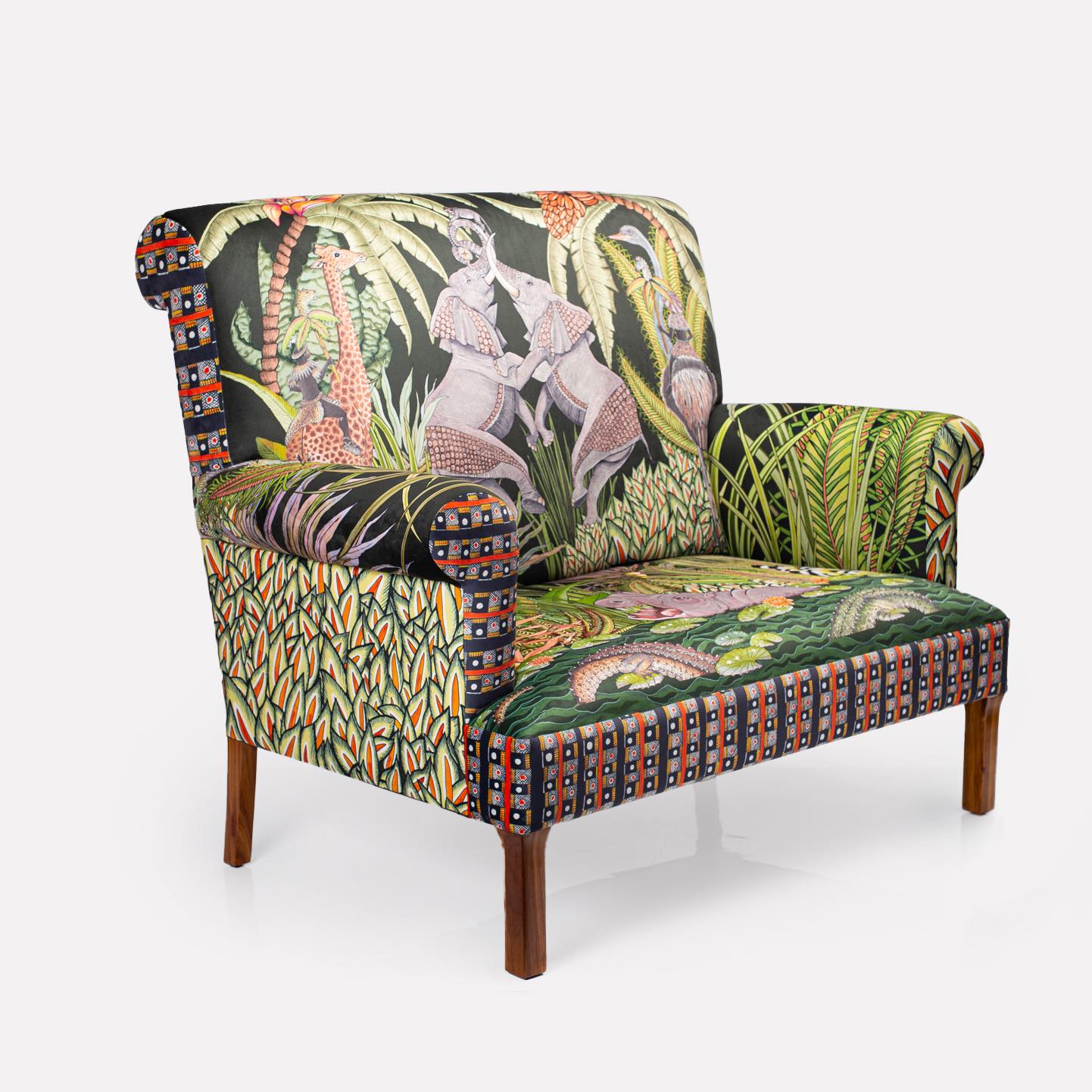 Angled view of the Ardmore Sabie Sofa, highlighting the intricate Zulu bead-inspired patterns on the armrests and wooden legs.