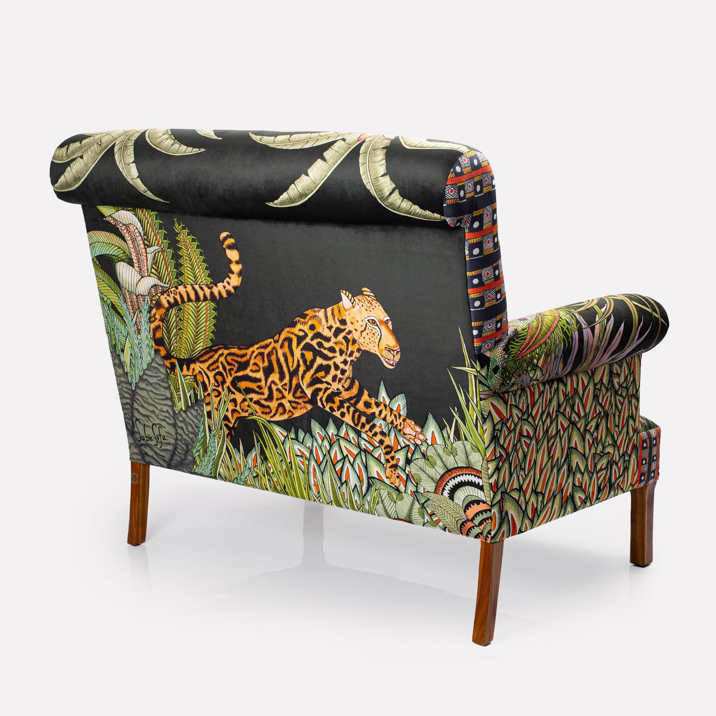 Rear view of the sofa, revealing the full tapestry of jungle elements and intricate craftsmanship.