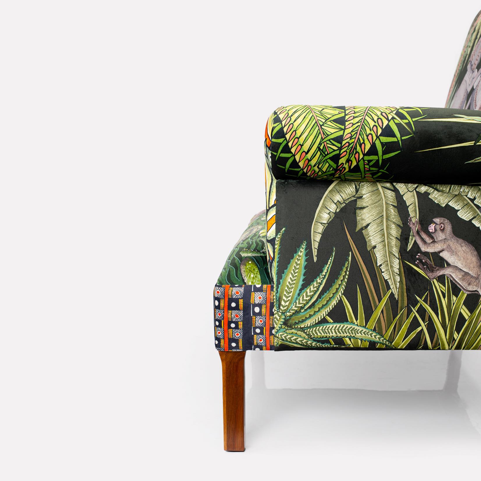 Wooden leg close-up, showcasing the polished mahogany finish that complements the bold upholstery.