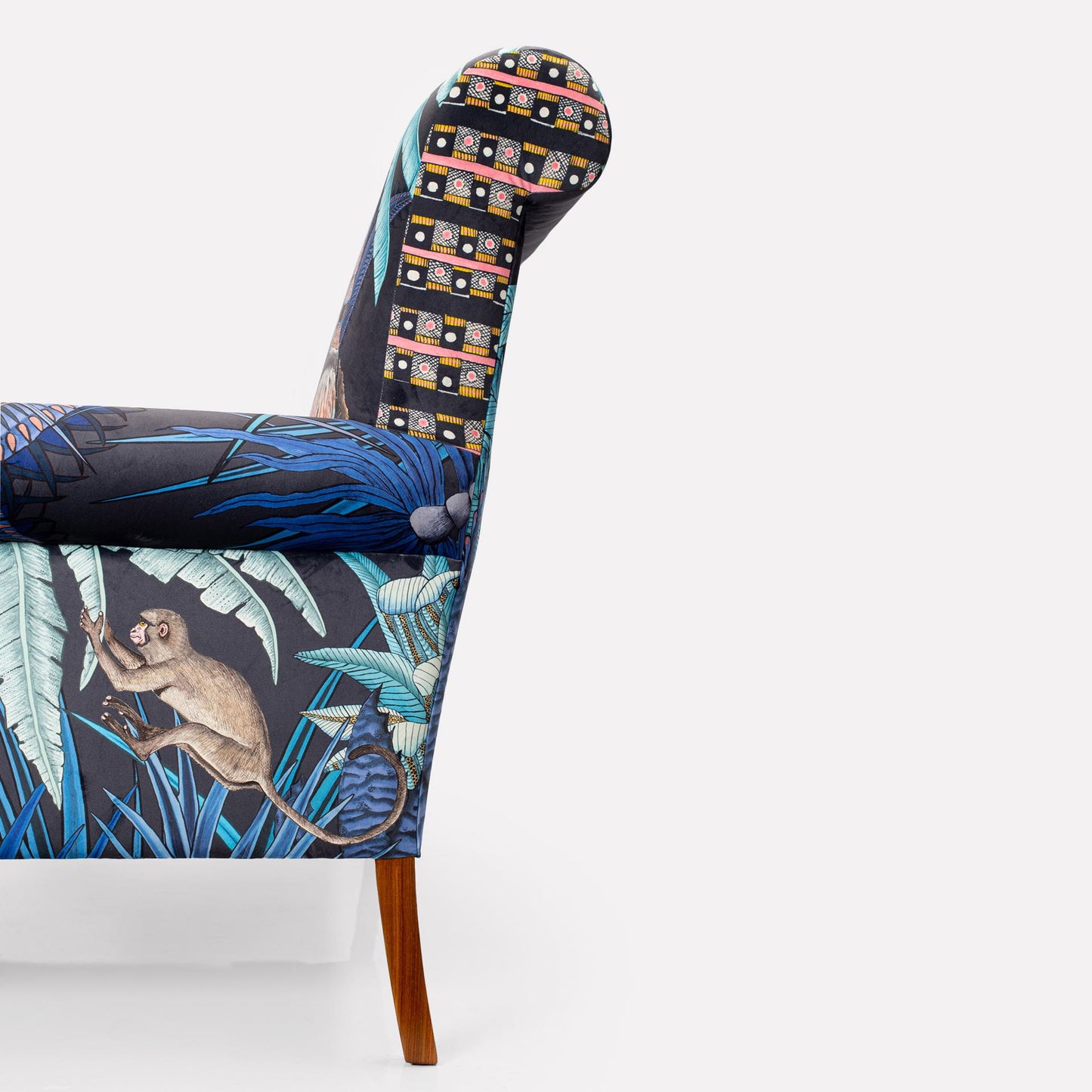 A clean profile shot of the left side, showing the seamless upholstery and smooth wooden hind leg.