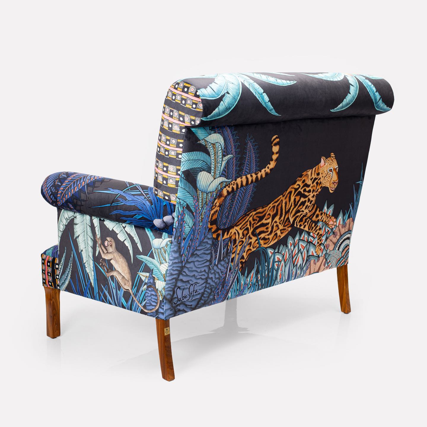 A three quarter back-facing image of the sofa, revealing how the intricate tapestry extends seamlessly across the back panel.