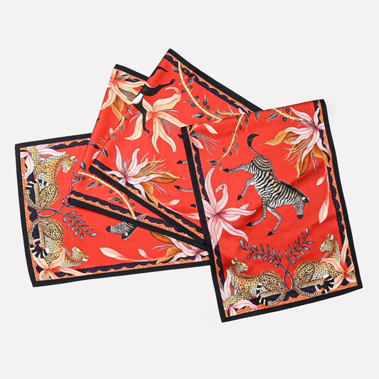 A set of Ardmore's Sable Runners in a vibrant Royal Red colour, featuring intricate depictions of leopards, jackals, and lush foliage.