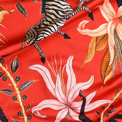 A zoomed-in section highlighting the fine artistic detailing of leopards, jackals, and exotic floral elements on the table runner.