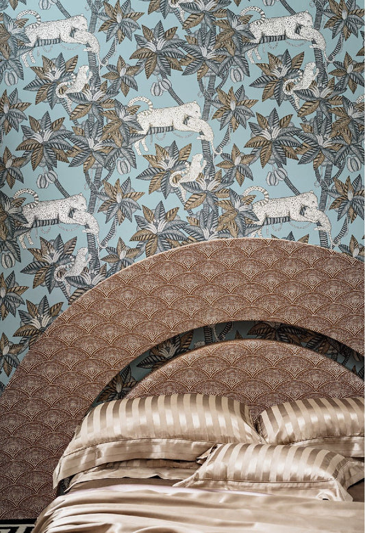 A detailed view of the Satara wallpaper featuring intricate foliage, leopards, and a dreamy mica sheen background, elegantly framed by layered woven décor elements.