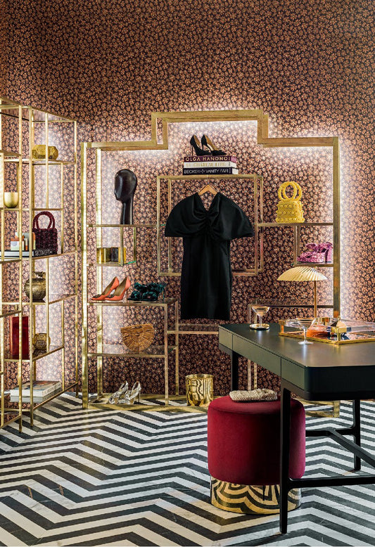 A beautifully designed walk-in wardrobe featuring Savanna Shell wallpaper in a warm, metallic terracotta shade, complementing the chic décor.