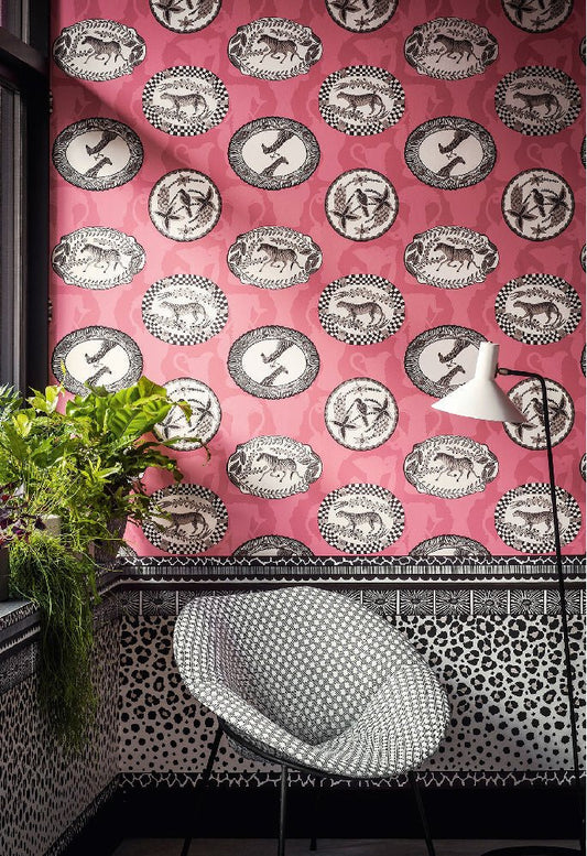 A beautifully decorated room featuring the wallpaper’s intricate ornamental platter motifs in a rich crimson palette.
