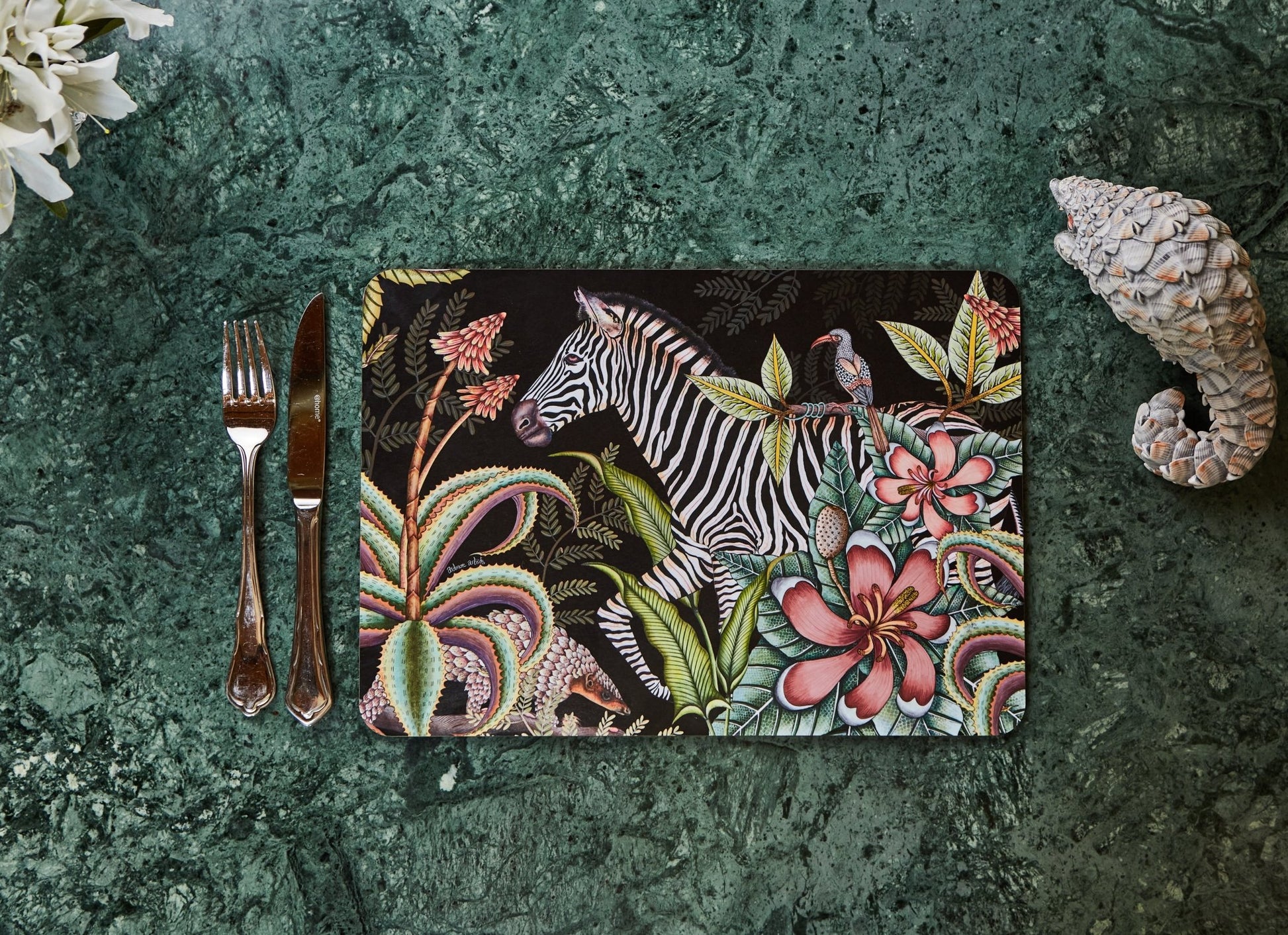 The placemat set elegantly displayed on a dining table with complementary decor, showcasing its sophisticated aesthetic.